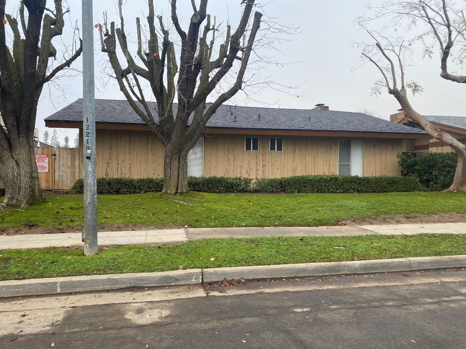 a house that has a tree in front of it