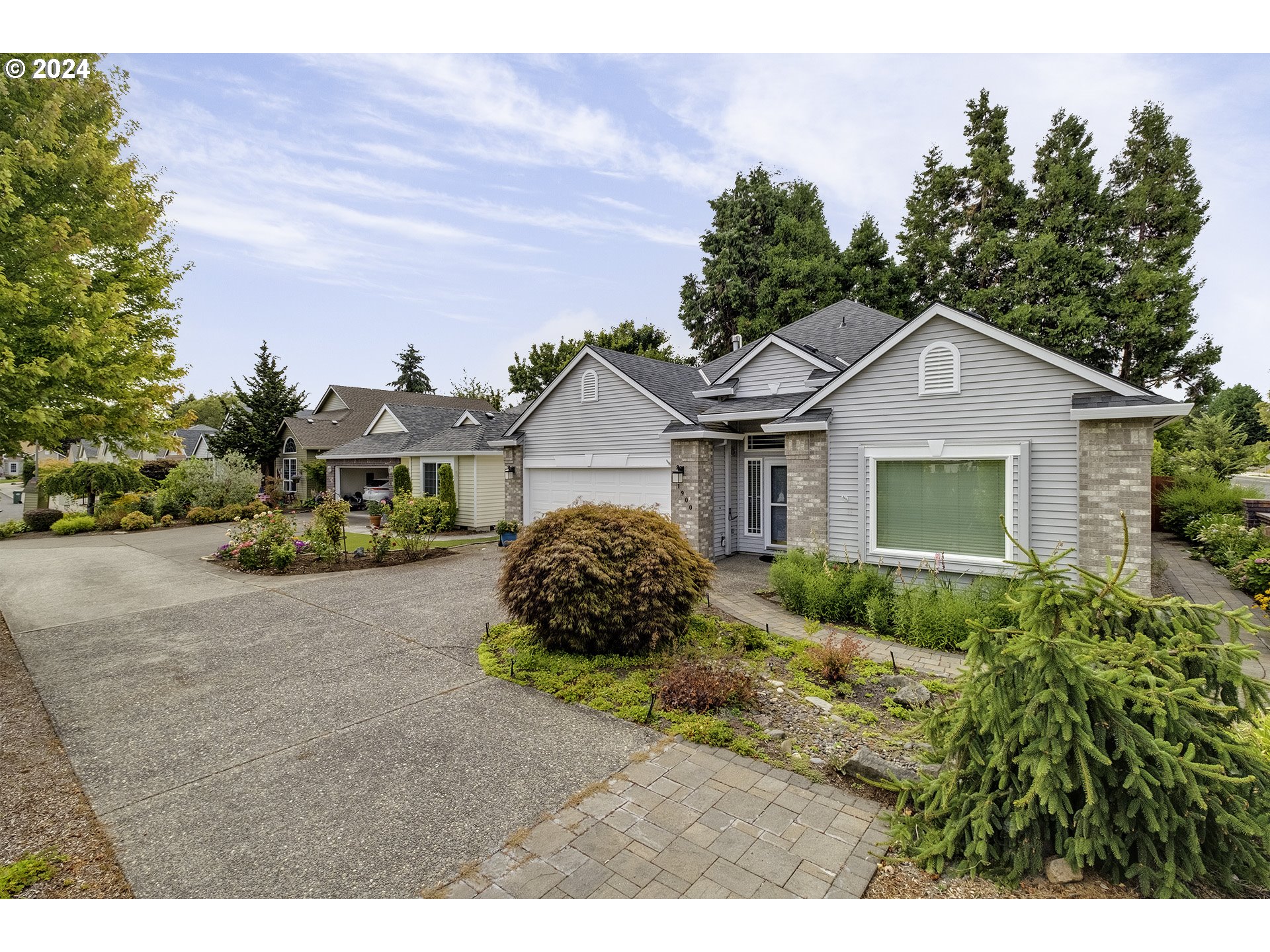 a front view of a house with a garden