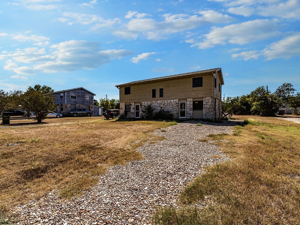 a view of house with yard and outdoor space