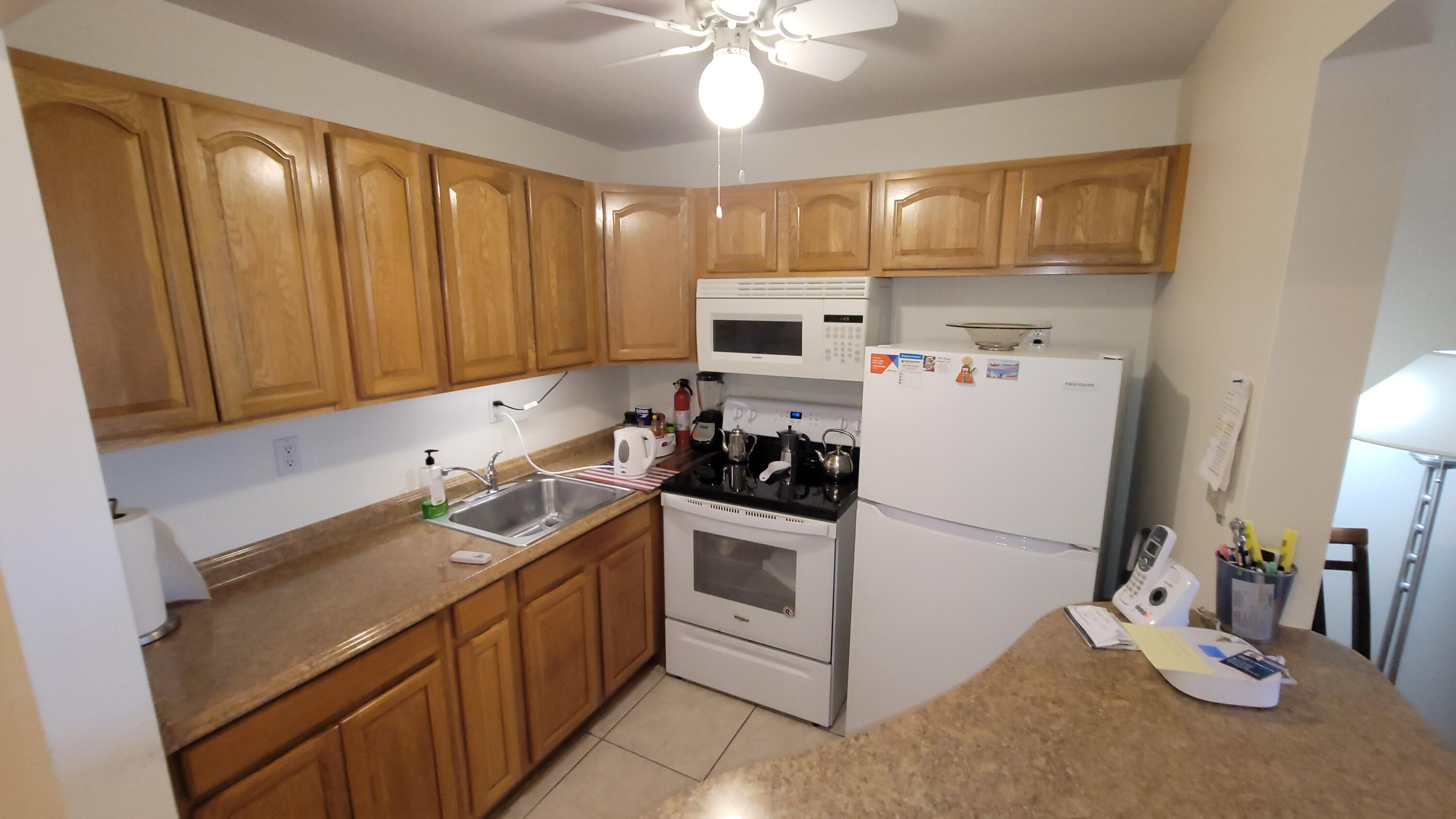 a kitchen with a sink stove and refrigerator