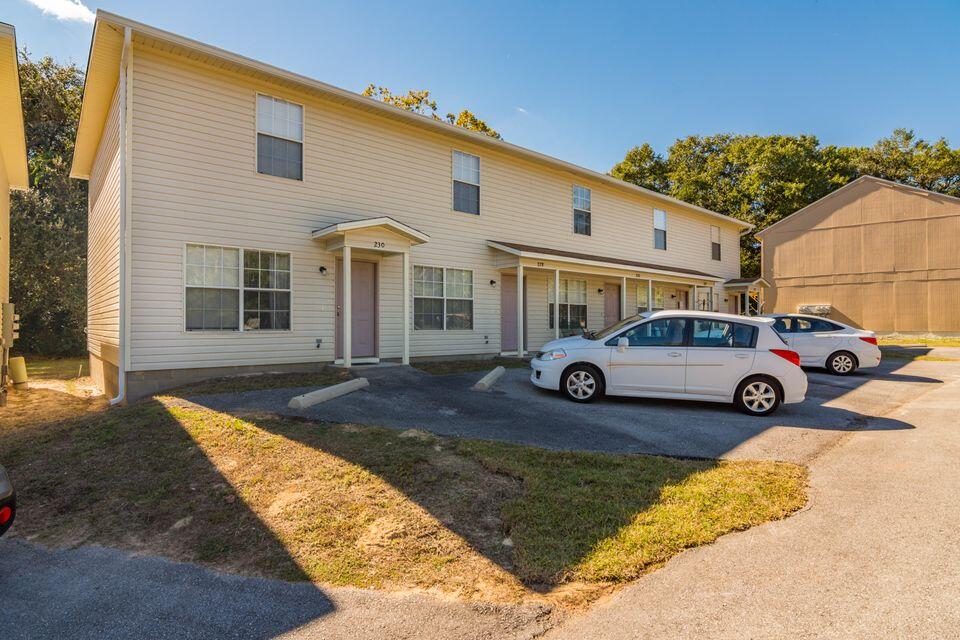 a front view of a house with parking space