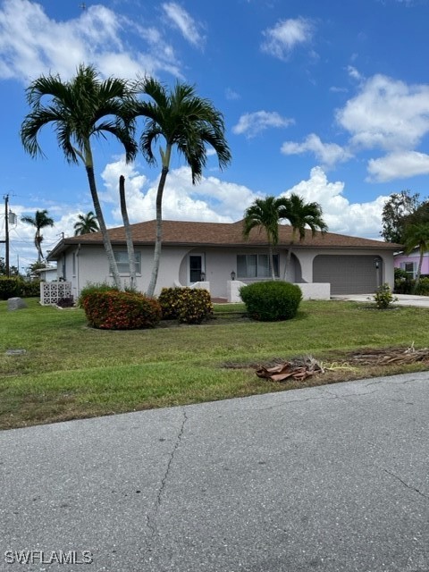 a front view of house with yard and outdoor seating