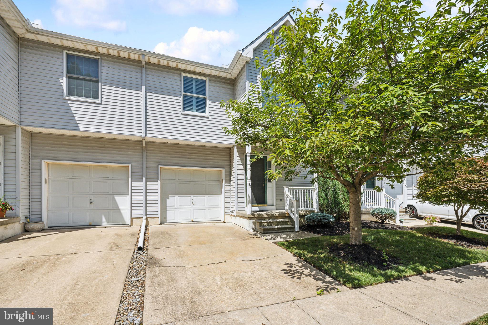 a view of a house with a yard and garage