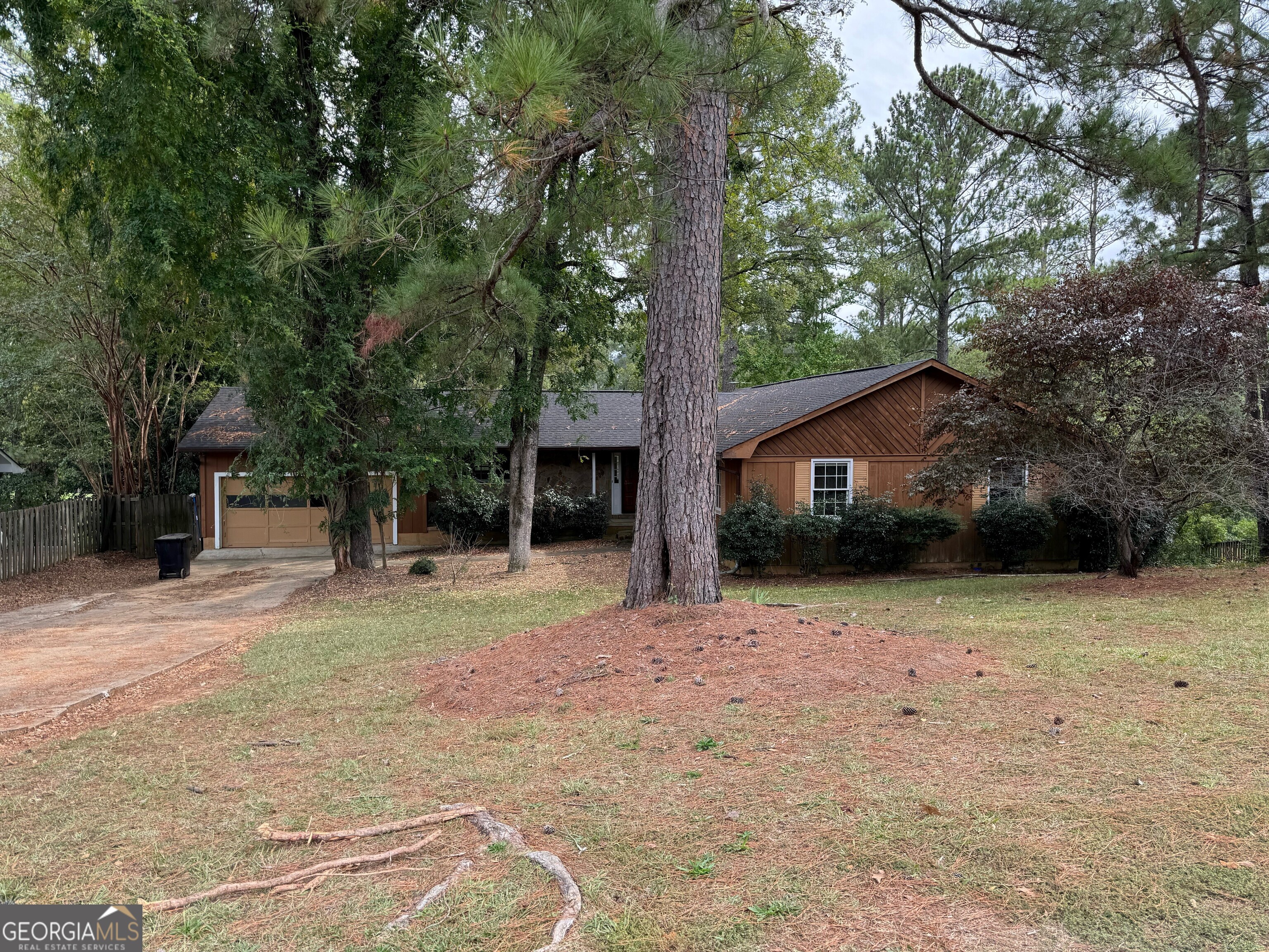 a front view of a house with a yard and trees