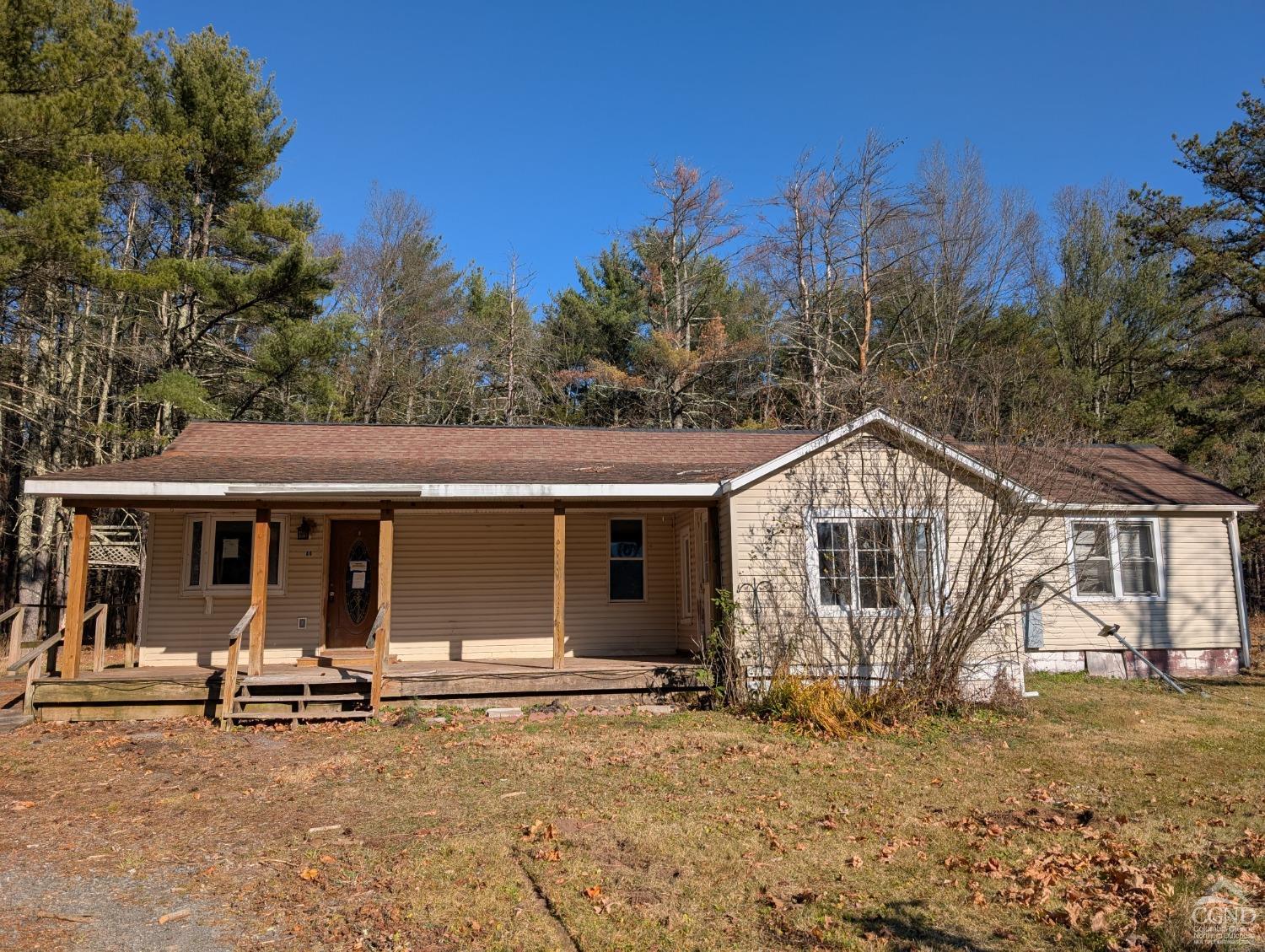 a view of a house with a yard and wooden fence