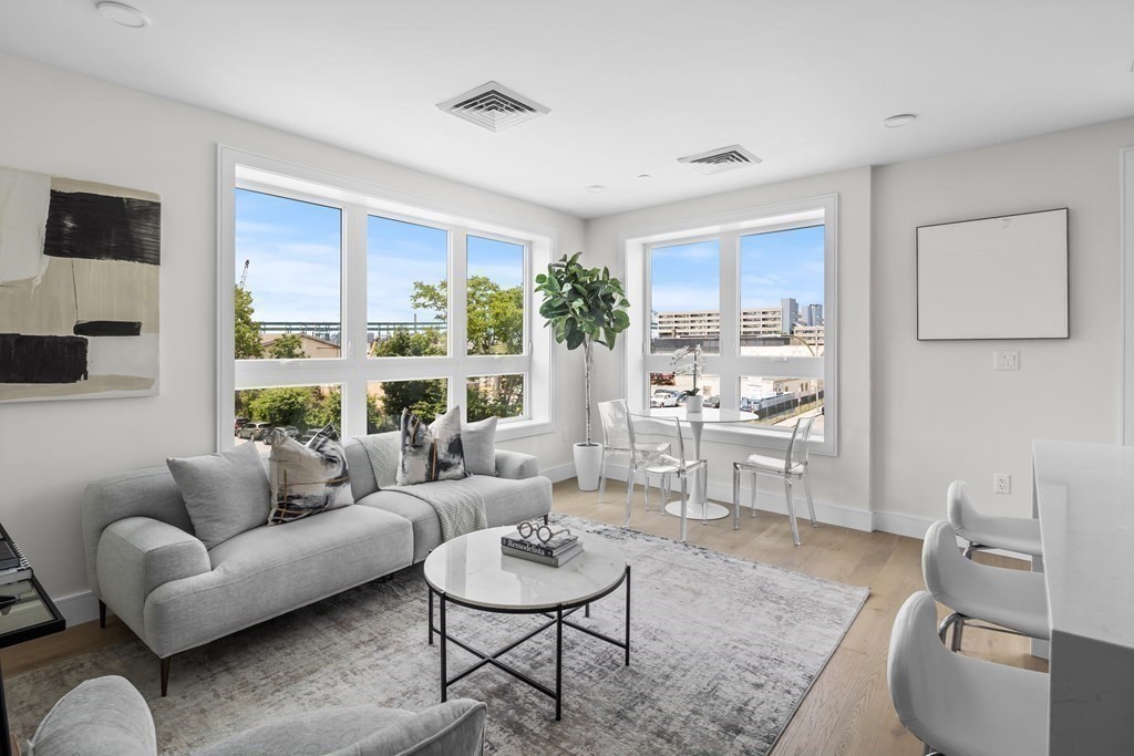 a living room with furniture and a large window