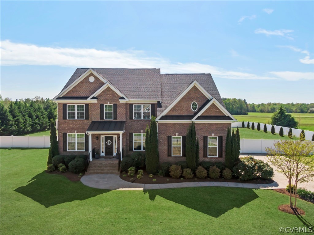 a front view of a house with a yard porch and outdoor seating