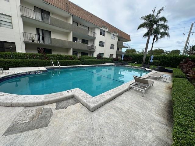 a view of a swimming pool with lounge chair