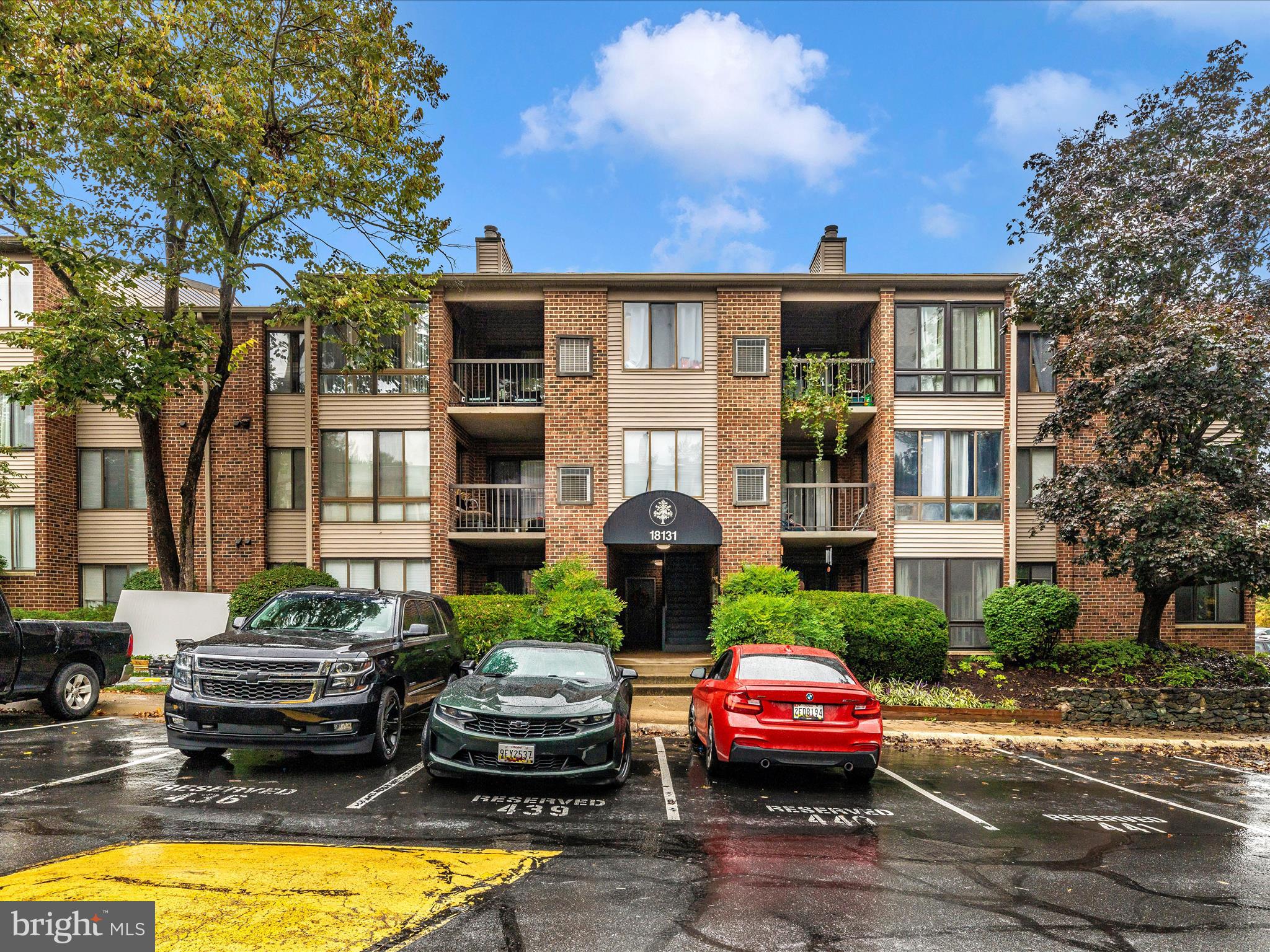 a front view of a house with cars parked