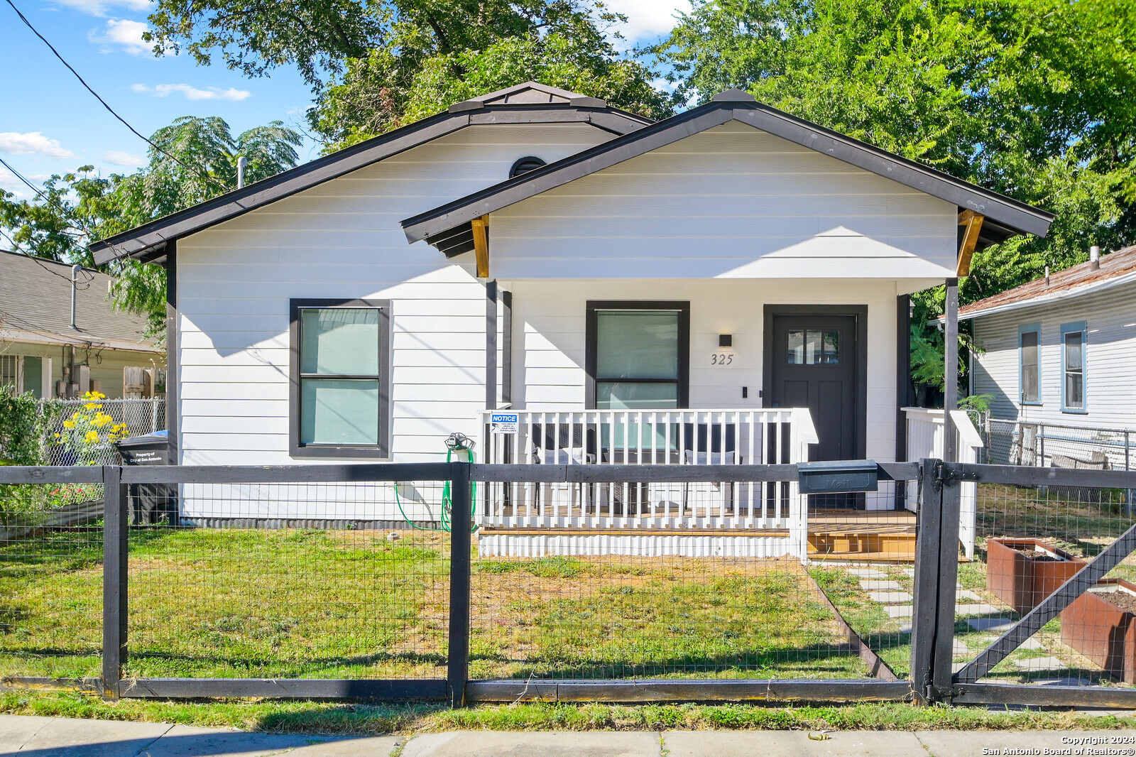 a view of a house with backyard and porch