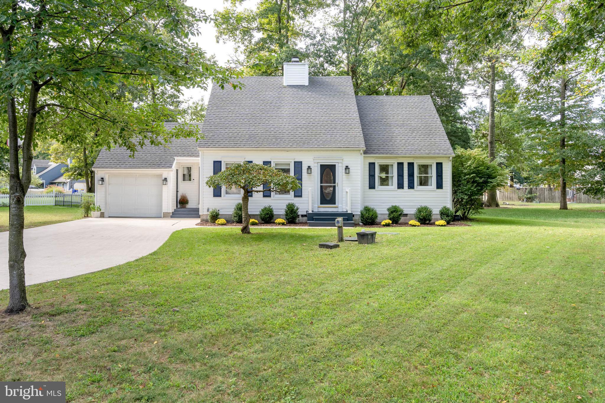 a view of a house with a backyard and a tree