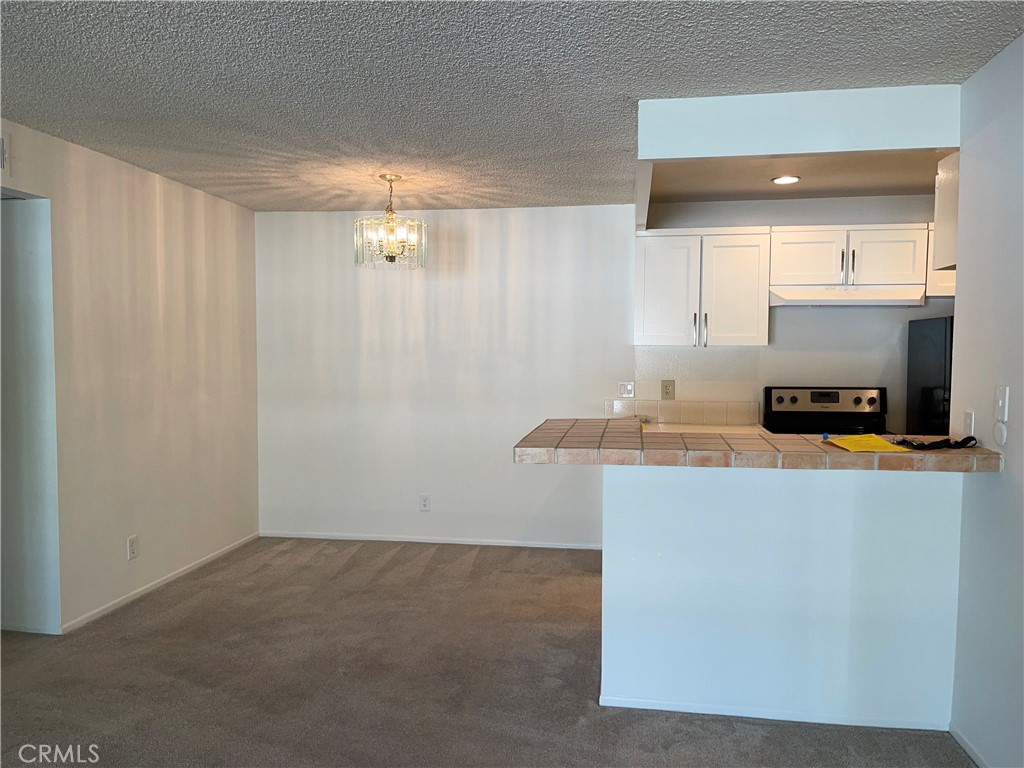 a kitchen with kitchen island a sink cabinets and appliances