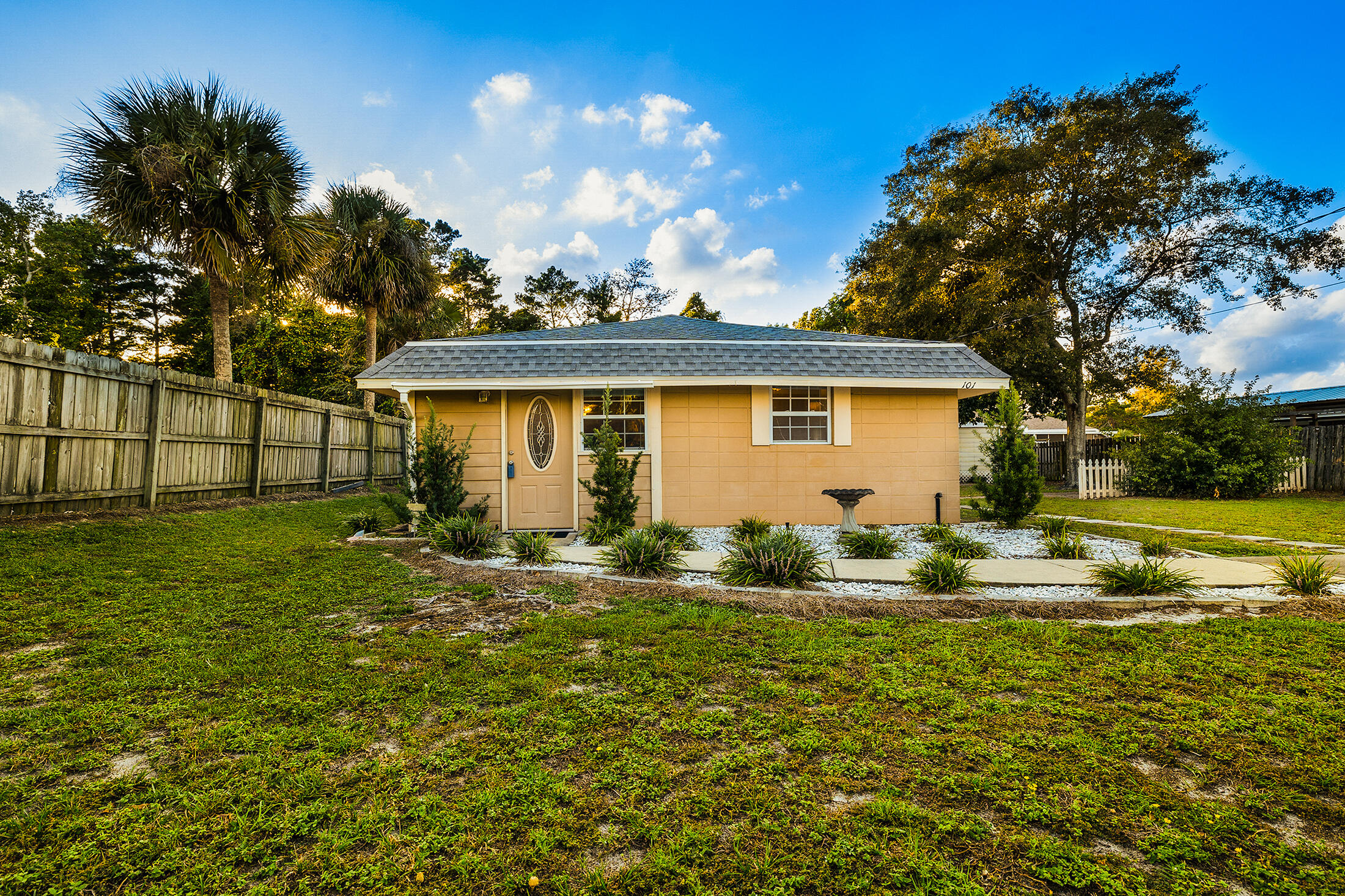 a backyard of a house with table and chairs