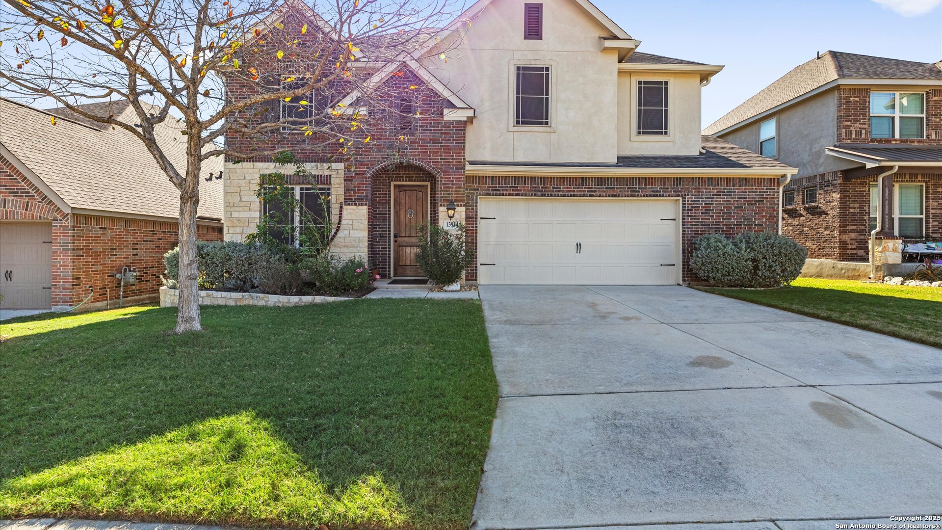 a front view of a house with a yard and garage