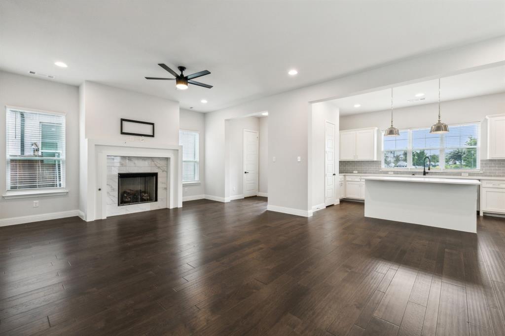 a view of a kitchen with wooden floor and a kitchen