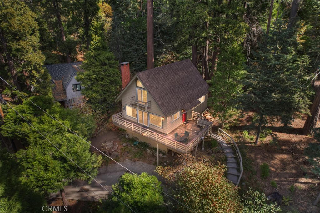 a view of a house with a yard and tree s