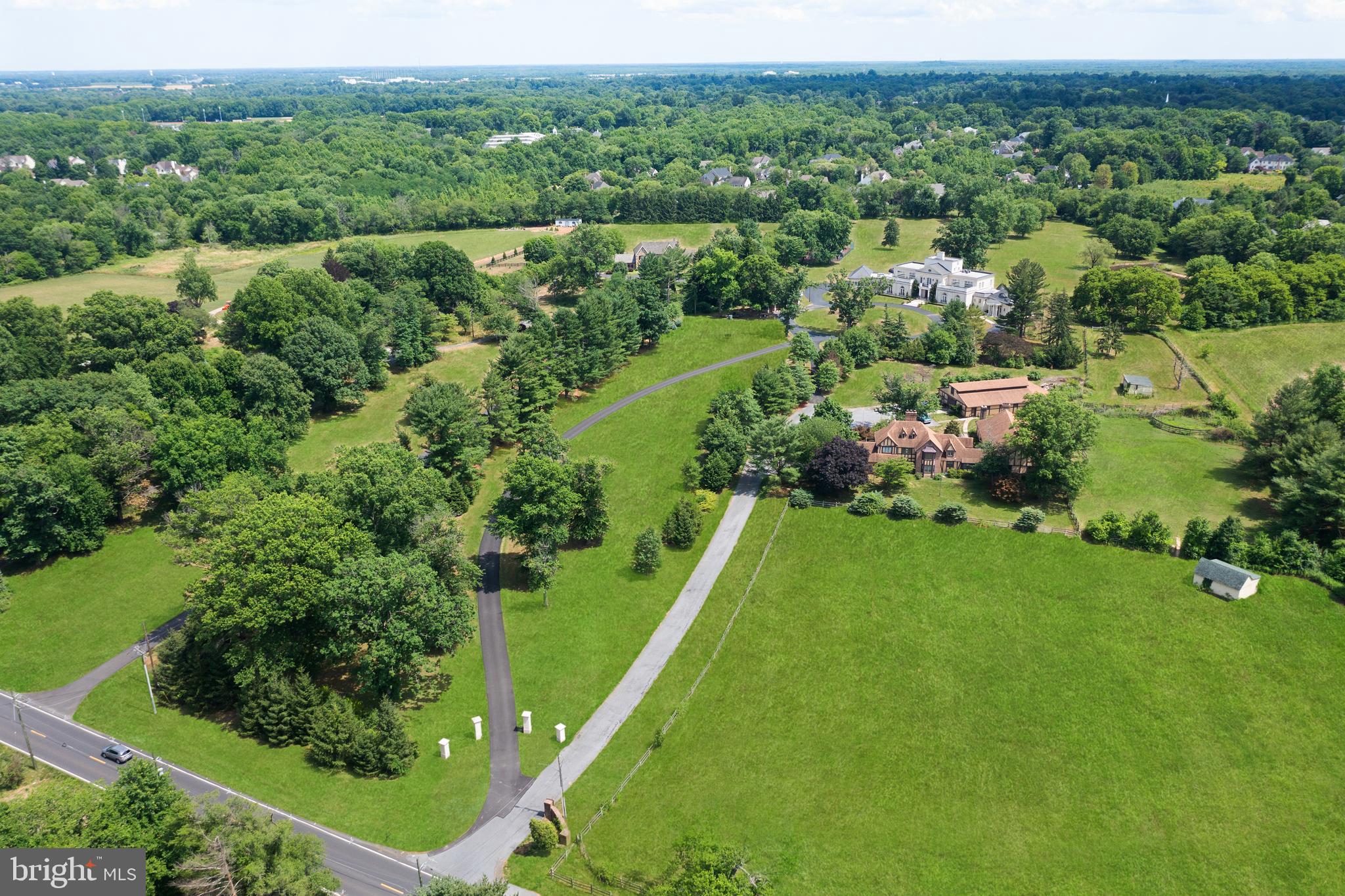 an aerial view of green landscape with trees houses and mountain view