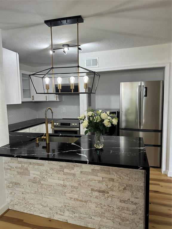 a kitchen with a stove and refrigerator