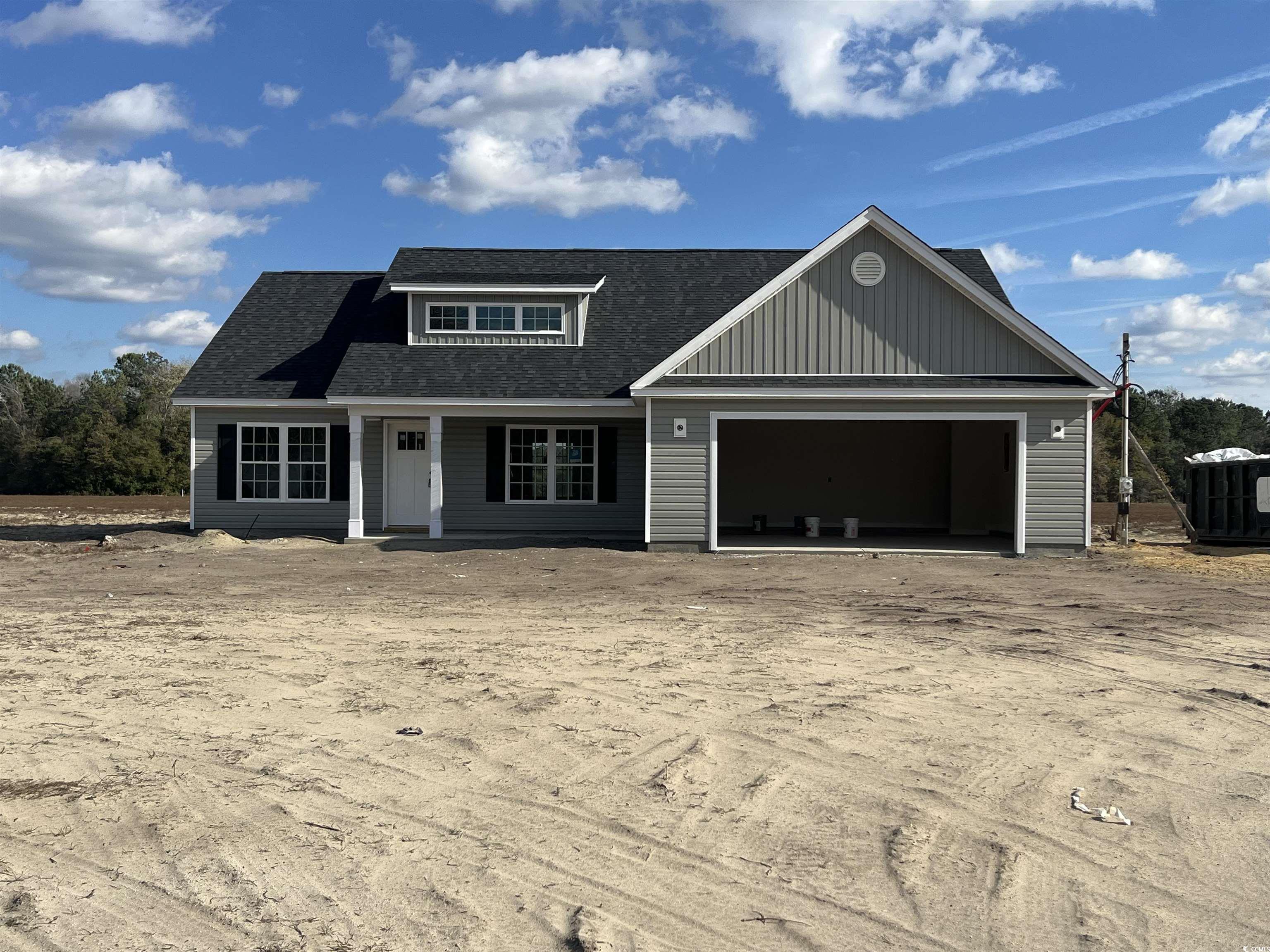 View of front facade featuring a garage