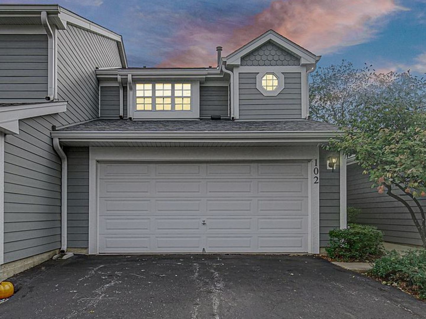 a front view of a house with a garage