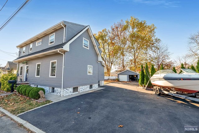 a view of a house with a yard and garage