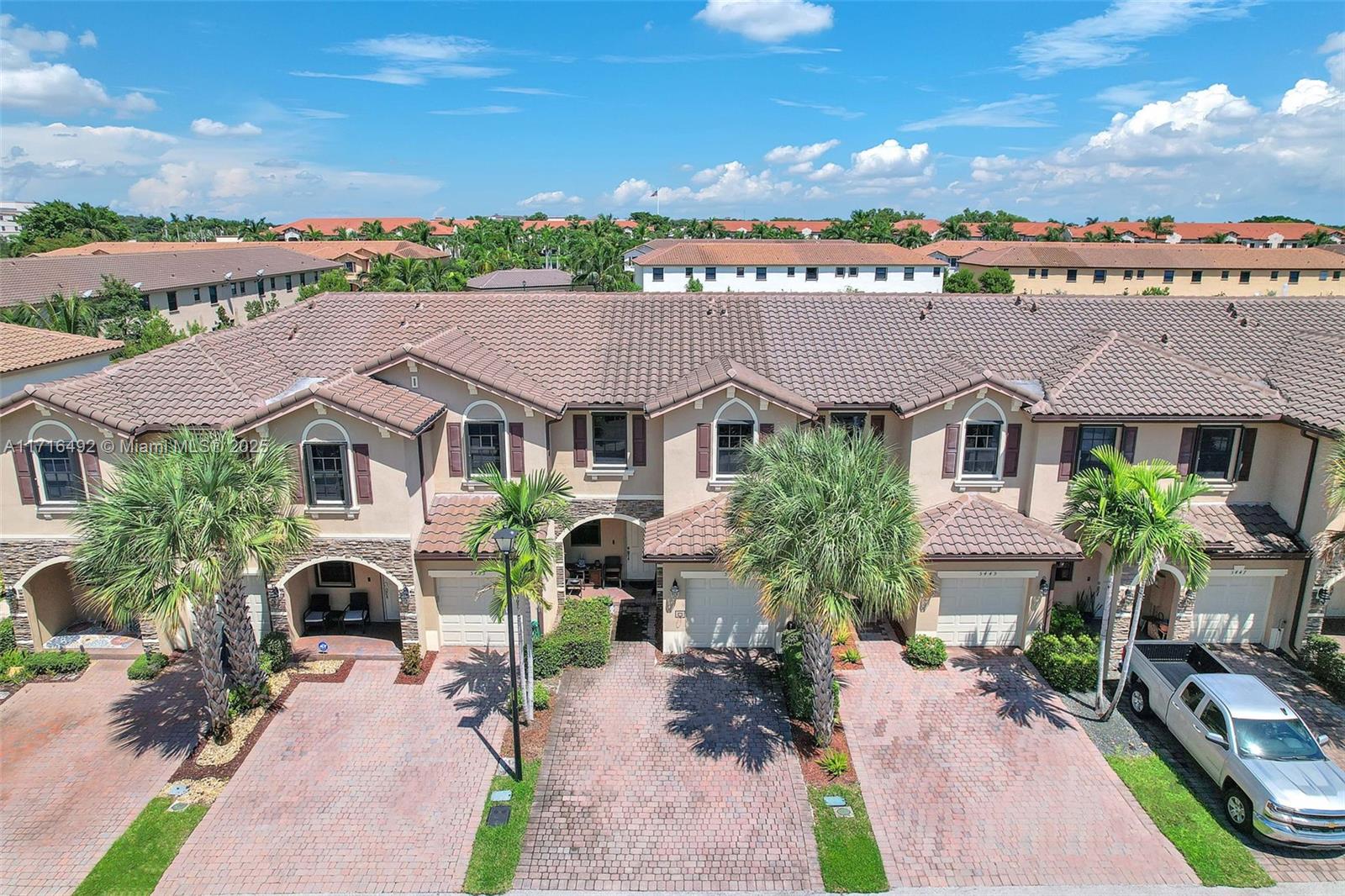 aerial view of a house with a yard and potted plants