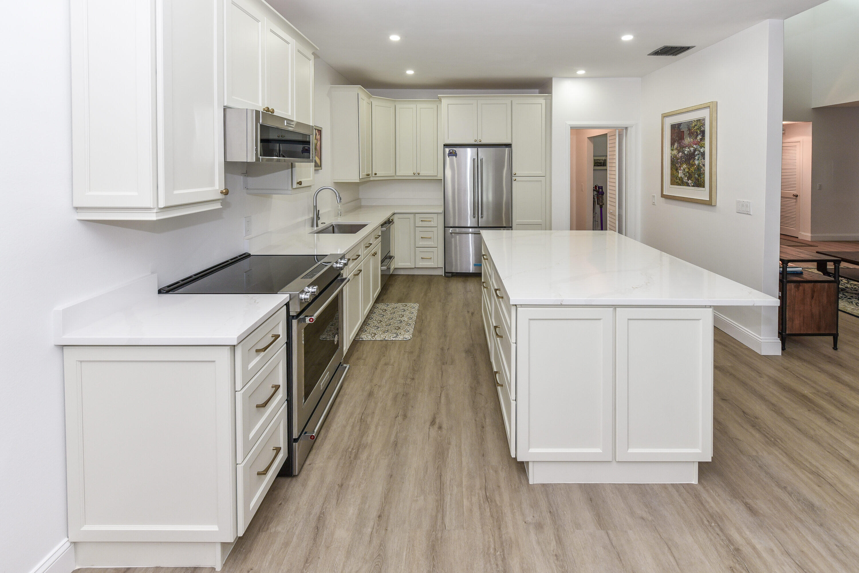 a kitchen with stainless steel appliances a refrigerator sink and microwave