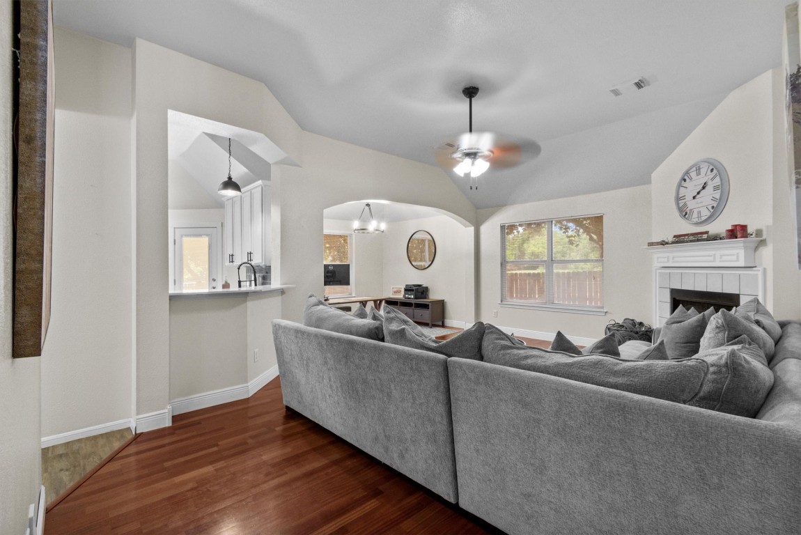 a living room with furniture chandelier and fireplace