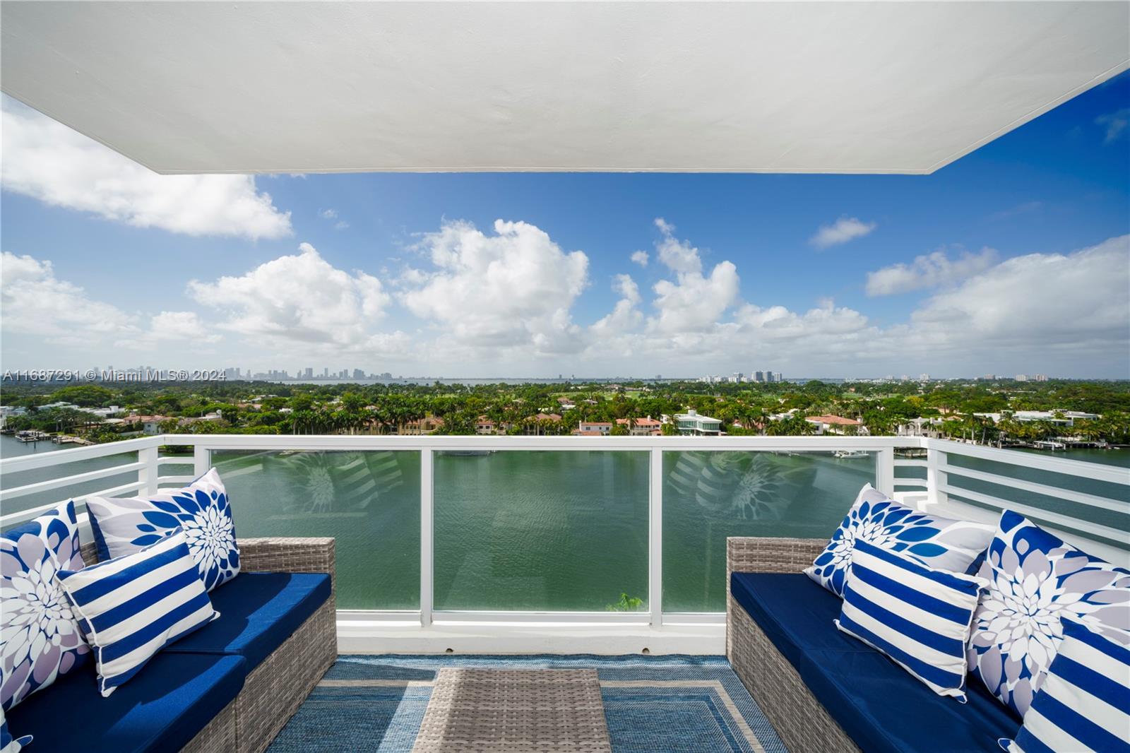 a view of a lake with couches chairs