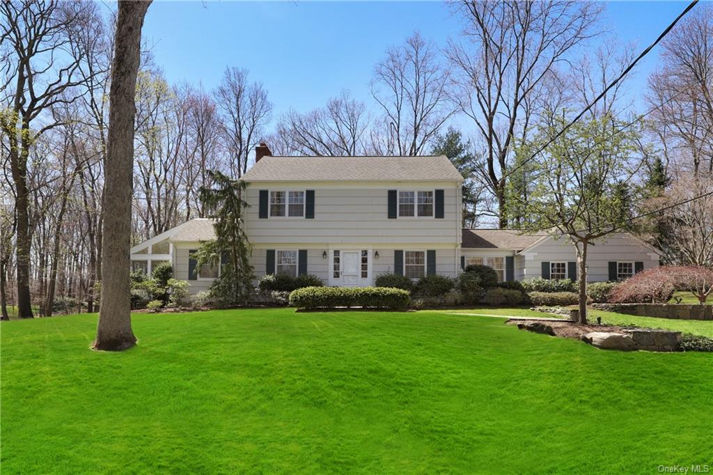 a front view of house with yard and green space