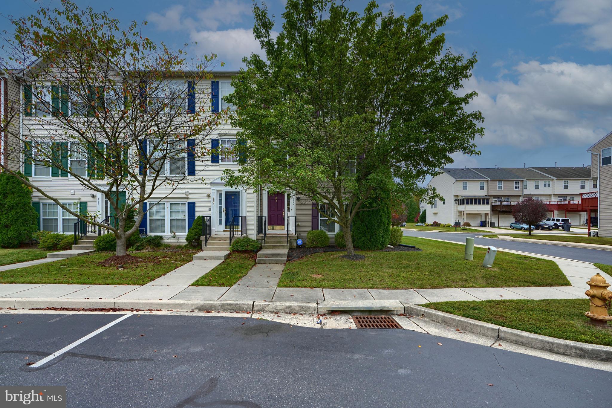 a view of a house with a yard and street