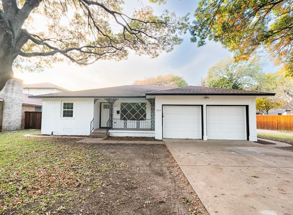 a view of a house with a yard and garage