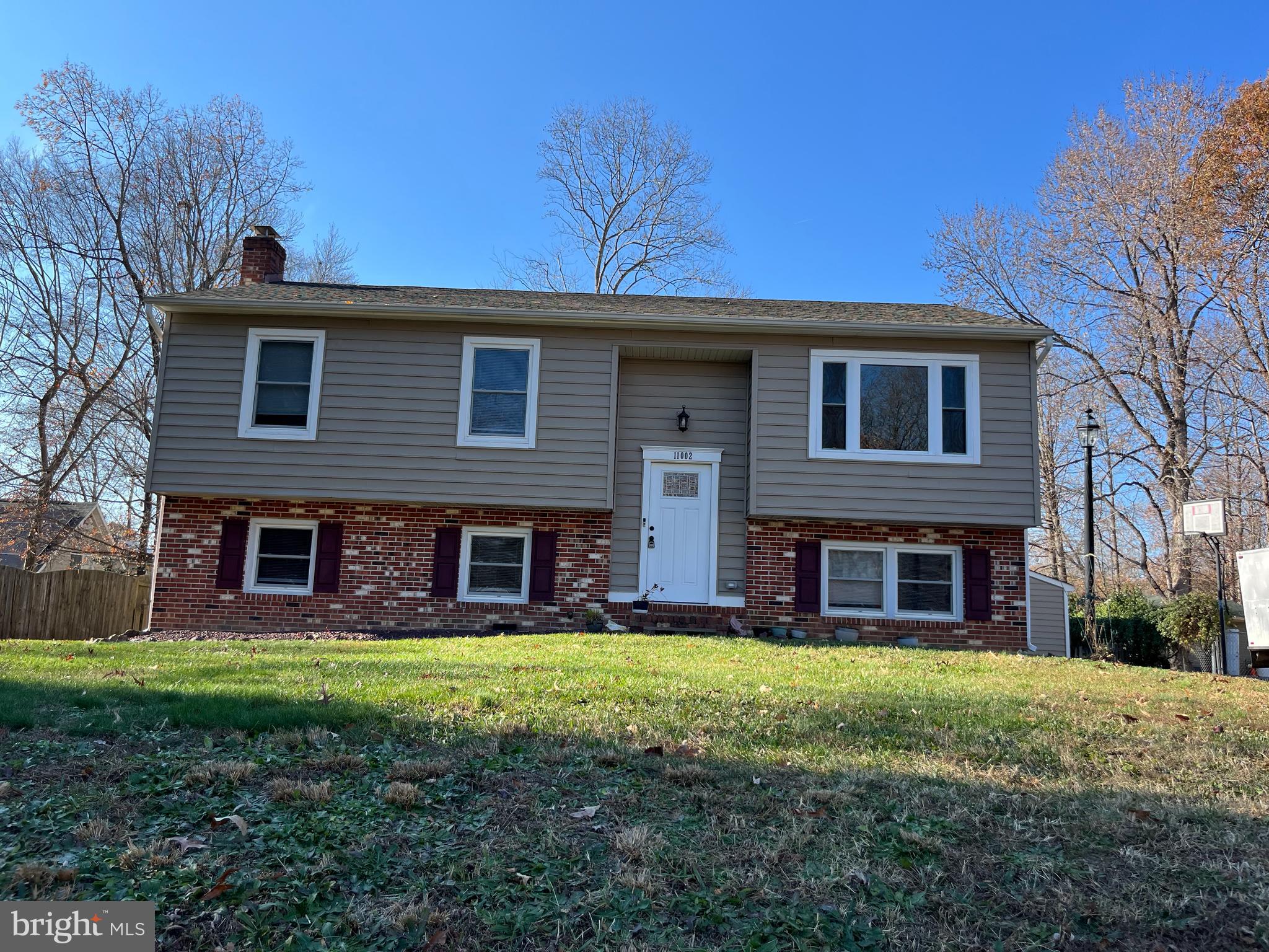 a view of a brick house with a yard