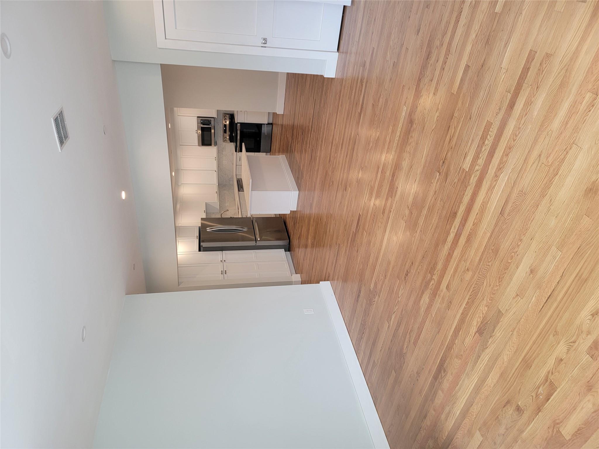 Unfurnished living room featuring light wood-type flooring