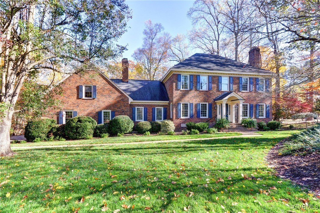 Colonial home featuring a front yard