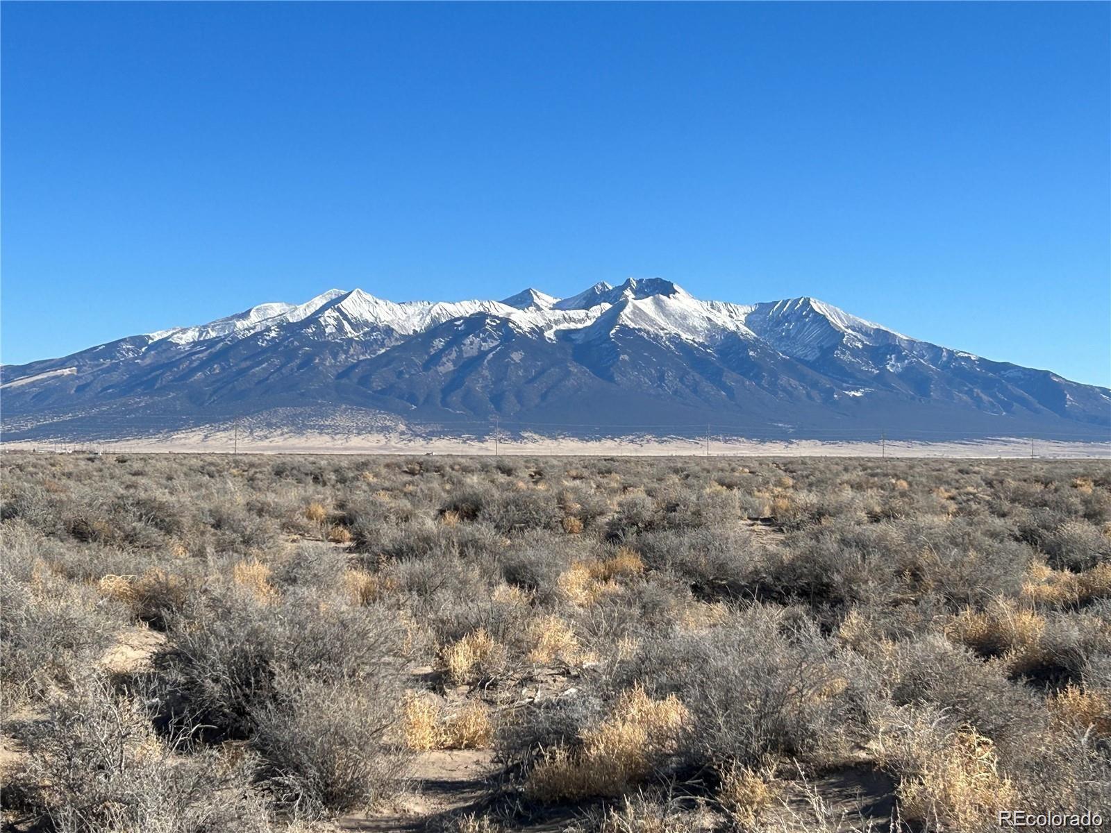 a view of a field with mountains in the background