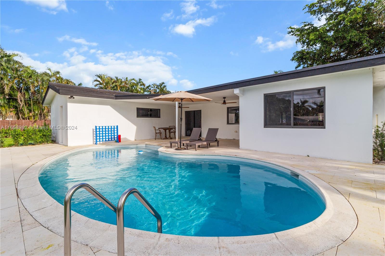 a view of swimming pool with outdoor seating