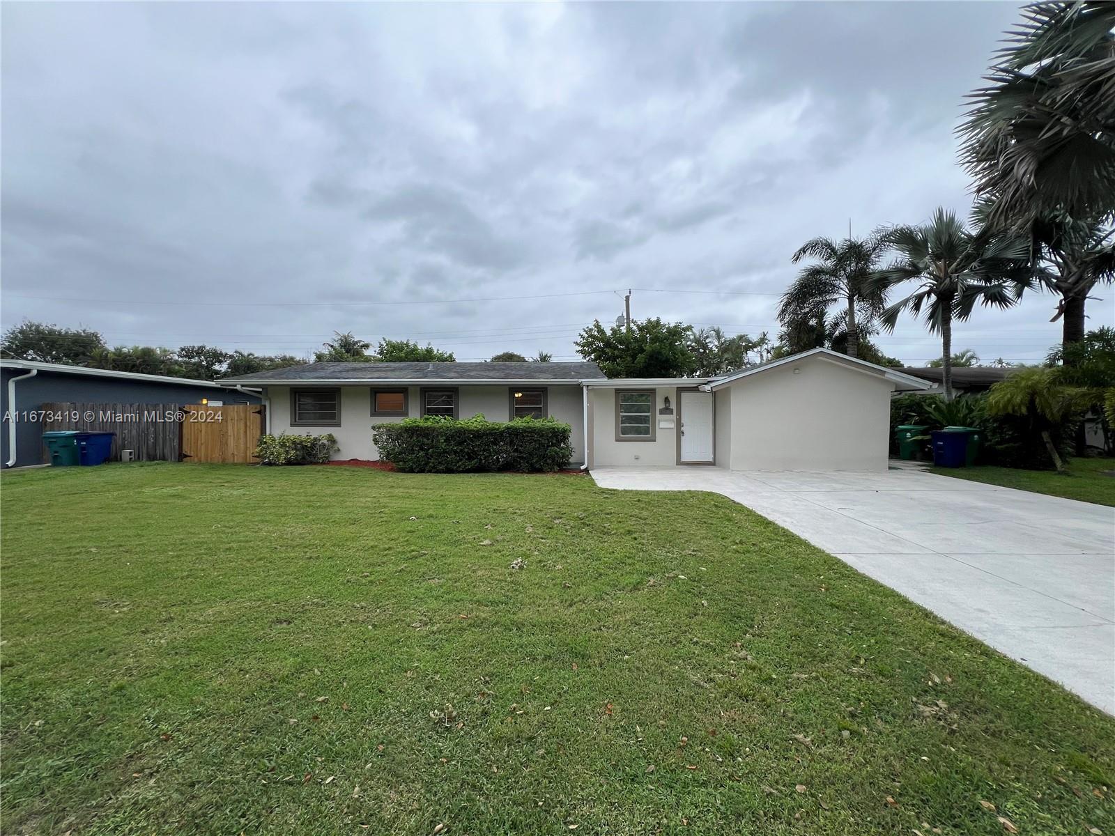 a view of a house with a backyard