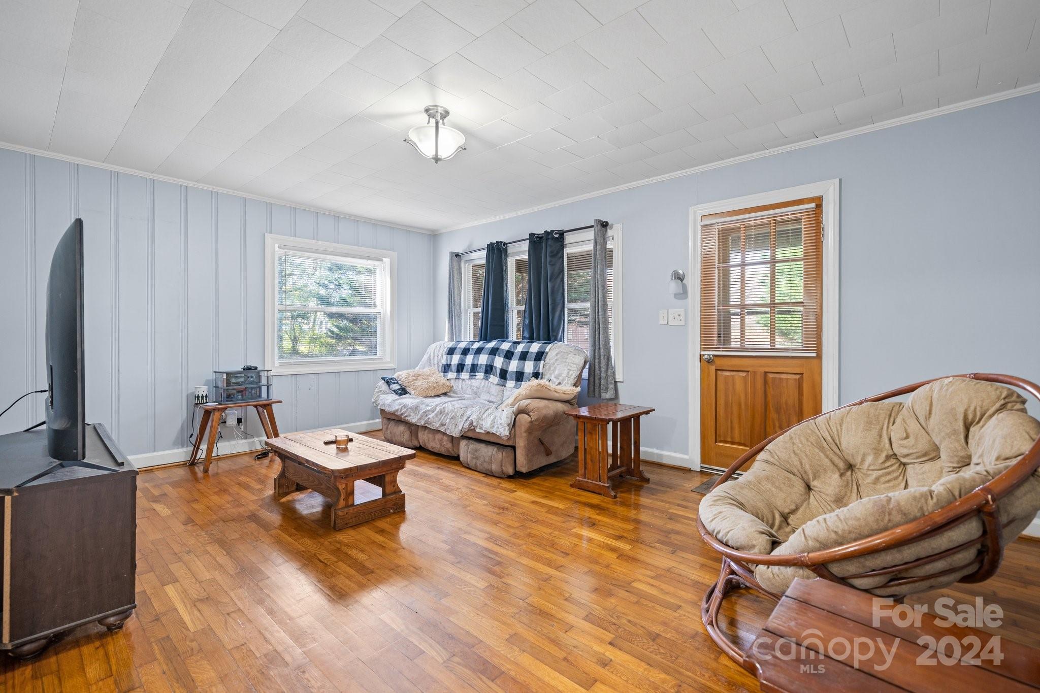 a living room with furniture and a flat screen tv