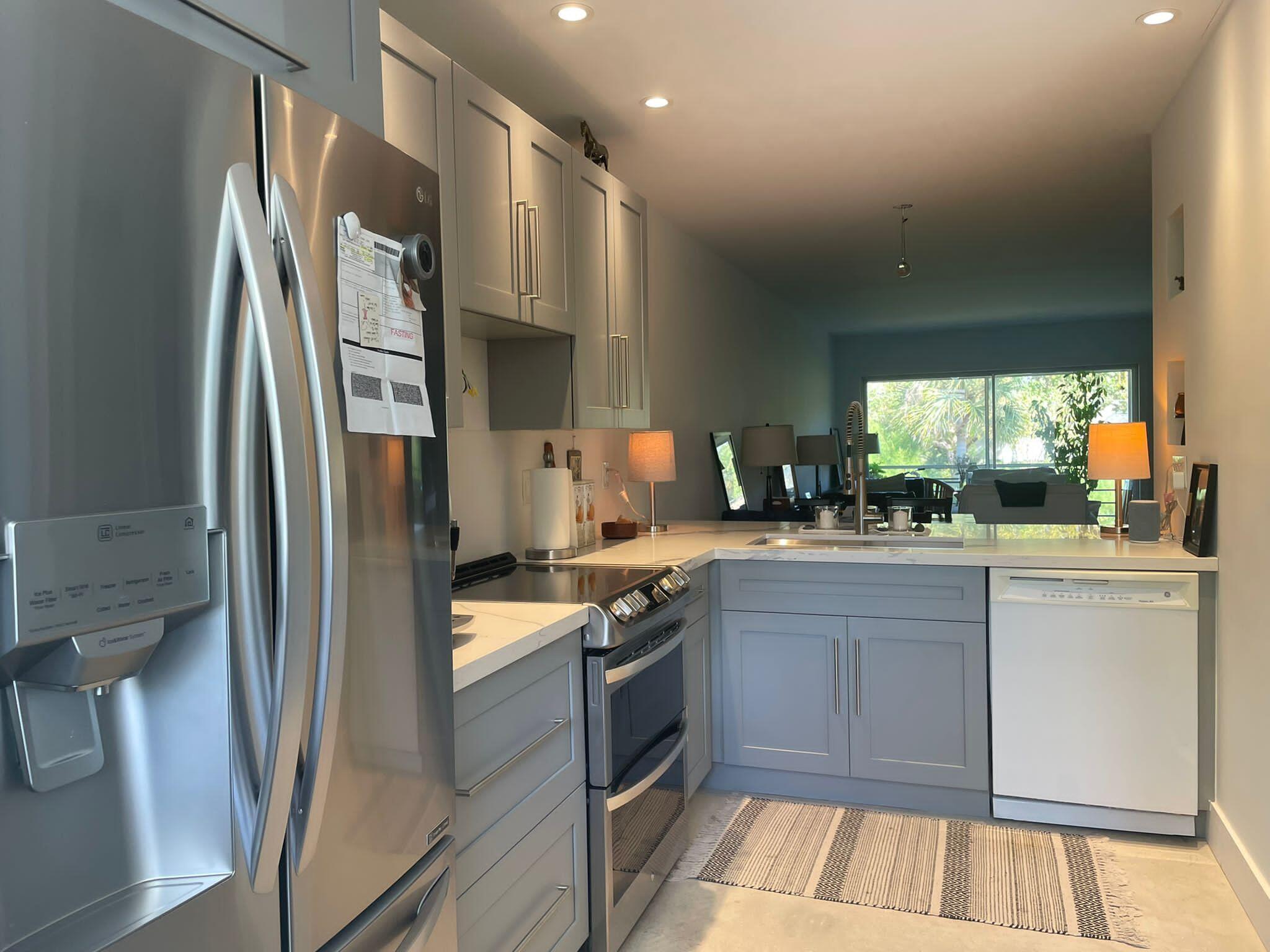 a kitchen with stainless steel appliances granite countertop a refrigerator and a stove