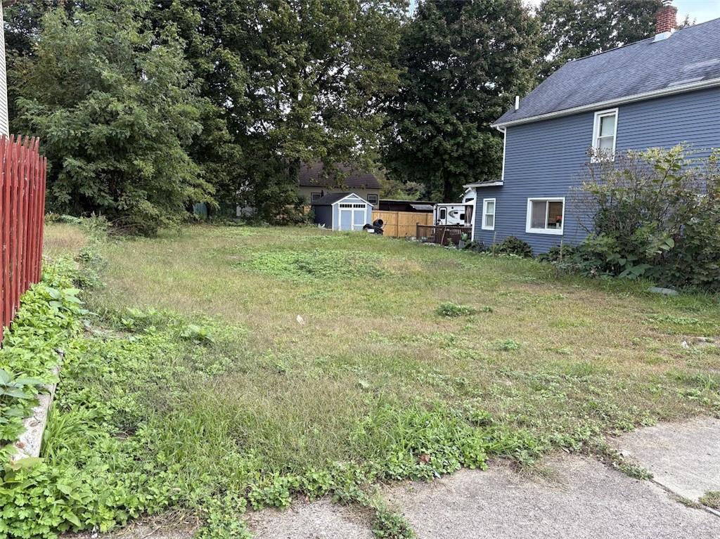 View of yard with a storage unit