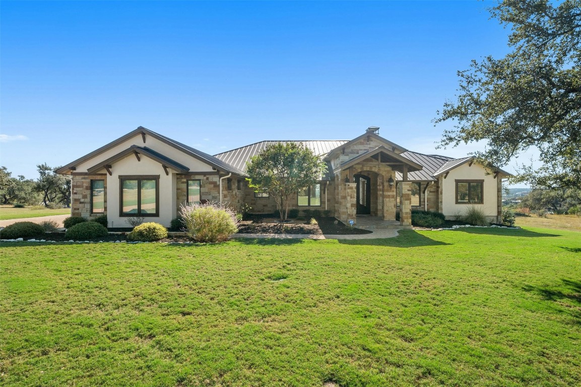 a front view of a house with garden