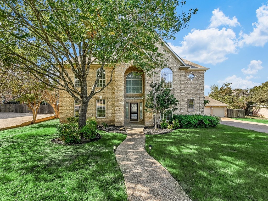 a front view of a house with garden