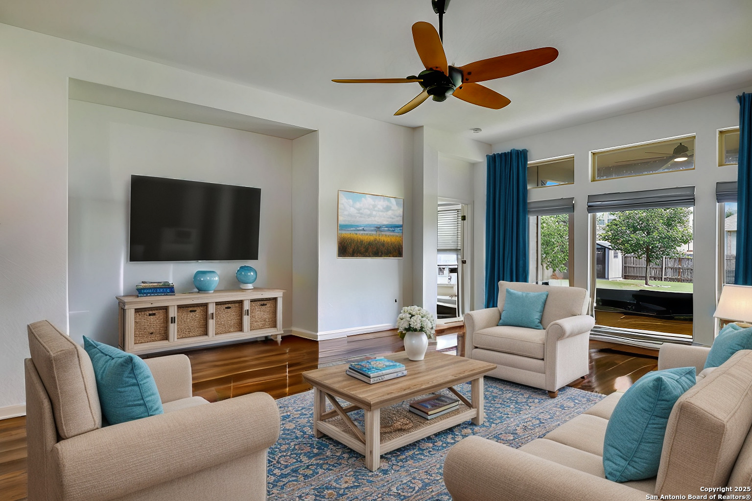 a living room with furniture a flat screen tv and a large window