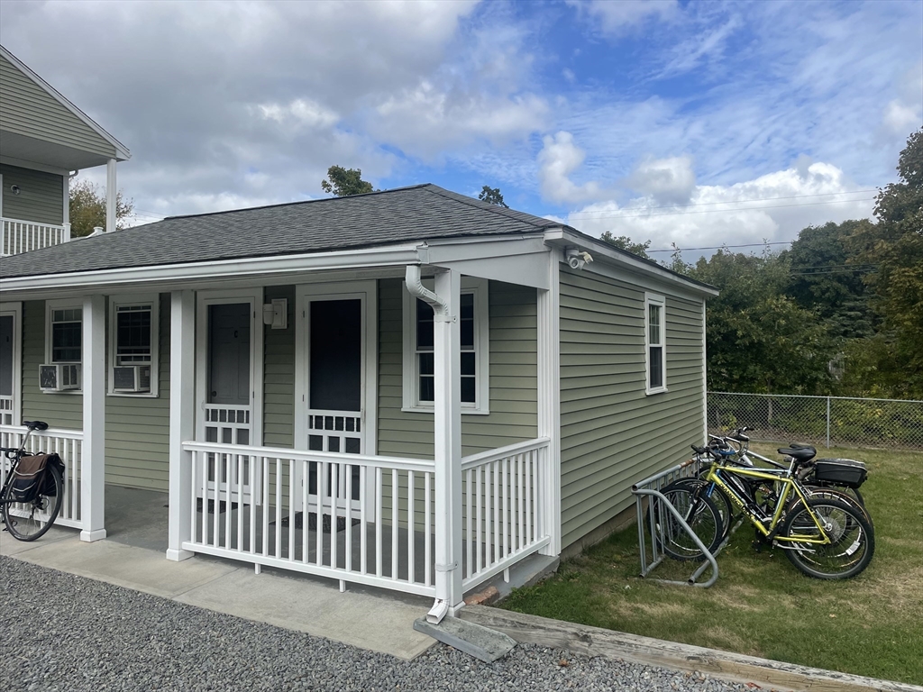 a view of a house with backyard and porch