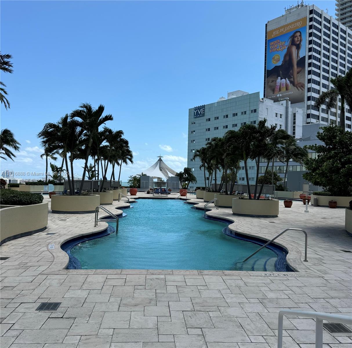 a view of swimming pool with outdoor seating and plants