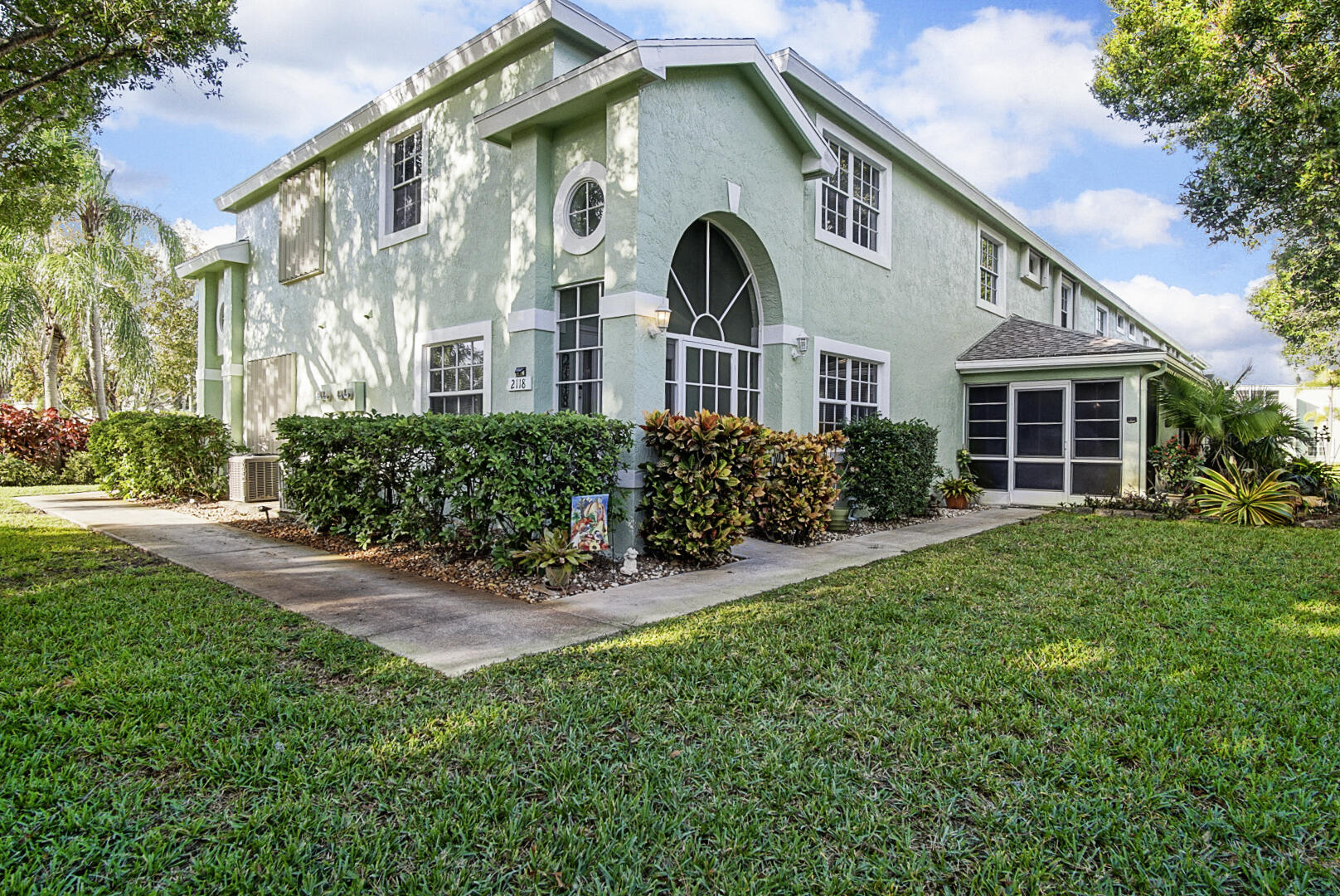 a front view of a house with a yard and porch