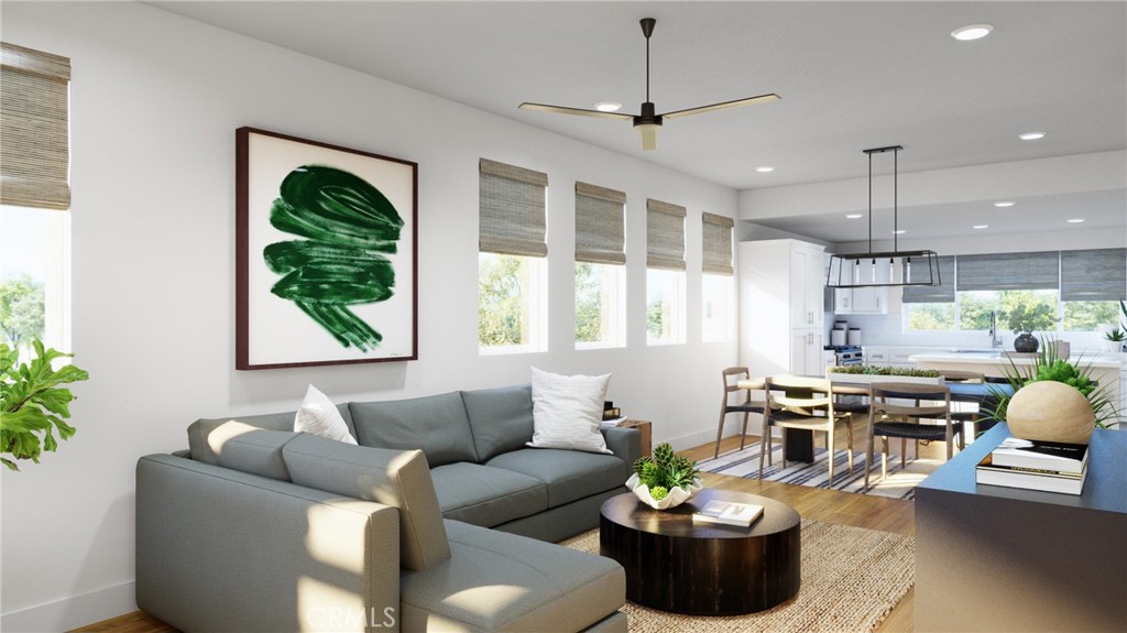 a living room with furniture potted plant and window