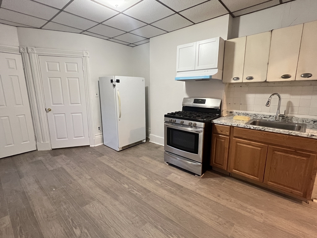 a kitchen with stainless steel appliances granite countertop a stove a sink and a refrigerator