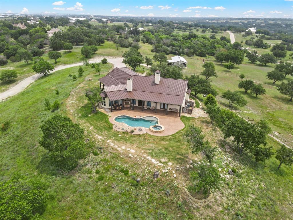 an aerial view of residential houses with outdoor space and river